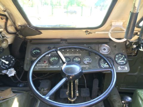 1993 Ford Bronco - The interior of a vehicle shows a complex dashboard with numerous gauges and a large steering wheel.