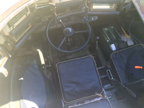 1993 Ford Bronco - Interior view of a vehicle, showing the steering wheel, seats, and dashboard with visible text.