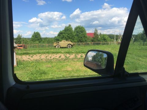 1993 Ford Bronco - An armored vehicle sits in a rural landscape under a cloudy sky.