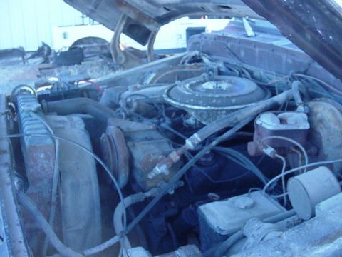 1992 Ford Bronco - The engine bay of a vehicle, showing the radiator and air cleaner assembly.