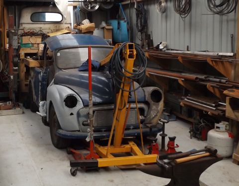 1969 MINI Cooper - A Morris Minor pickup truck in a workshop, undergoing restoration with an engine hoist positioned over it.