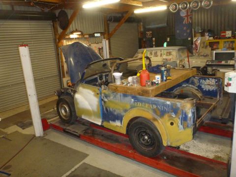 1969 MINI Cooper - Custom pickup truck undergoing work in a garage, with another vehicle in the background.