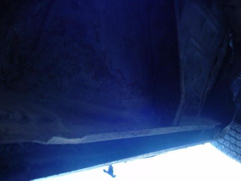 1992 Ford Bronco - Underside view of a vehicle frame, showing rust and a tire. Supermotors.net logo visible.