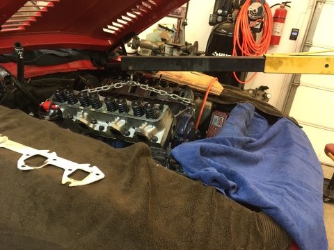 1968 Shelby GT500 - The engine bay of a vehicle is shown with the hood open and engine components exposed for work.