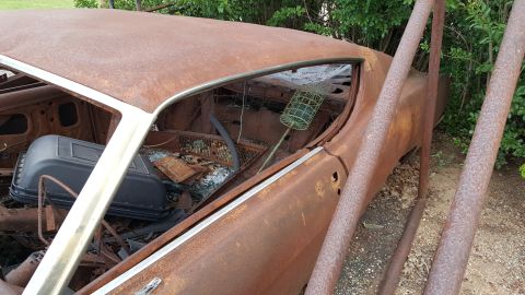 1973 Ford F-100 - Interior of a heavily rusted vehicle, showing damage and neglect.