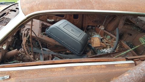 1973 Ford F-100 - The interior of this vehicle is heavily rusted and filled with debris, obscuring any identifying features.