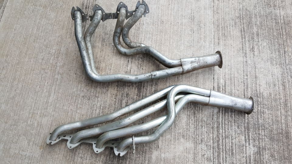 two exhaust manifolds on a concrete surface