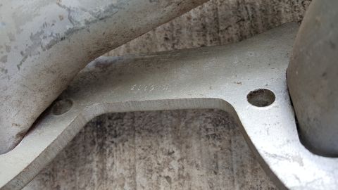 1973 Ford F-100 - A close-up view of a metal part shows stamped numbers, possibly a part number or date code.