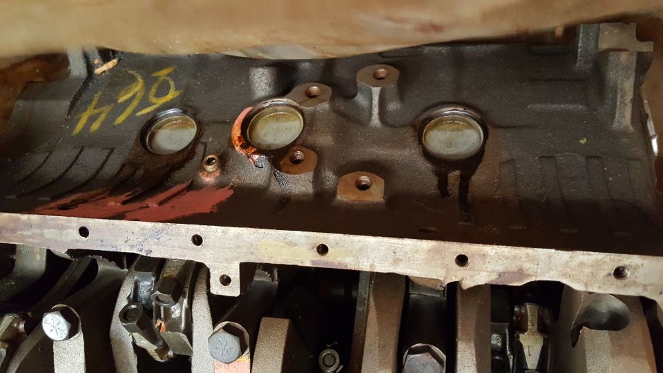 Engine block with crankshaft and connecting rods visible. Yellow markings on block