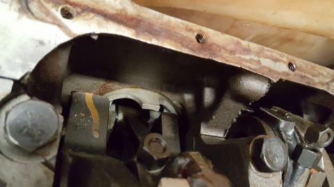 1973 Ford F-100 - Close-up view of damaged engine crankshaft and connecting rods, indicating internal engine failure.