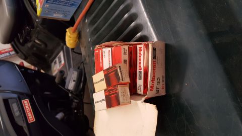 1973 Ford F-100 - Several boxes of Motorcraft BF32 spark plugs are stacked together, with some individual plugs visible.