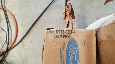 1973 Ford F-100 - A Ford damper is shown in its original packaging, with the part number D5TZ-6316-L clearly visible on the box.