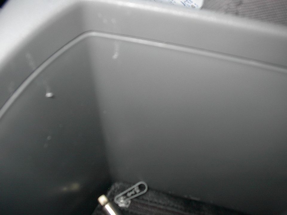 Interior storage compartment with a zippered pouch at the bottom