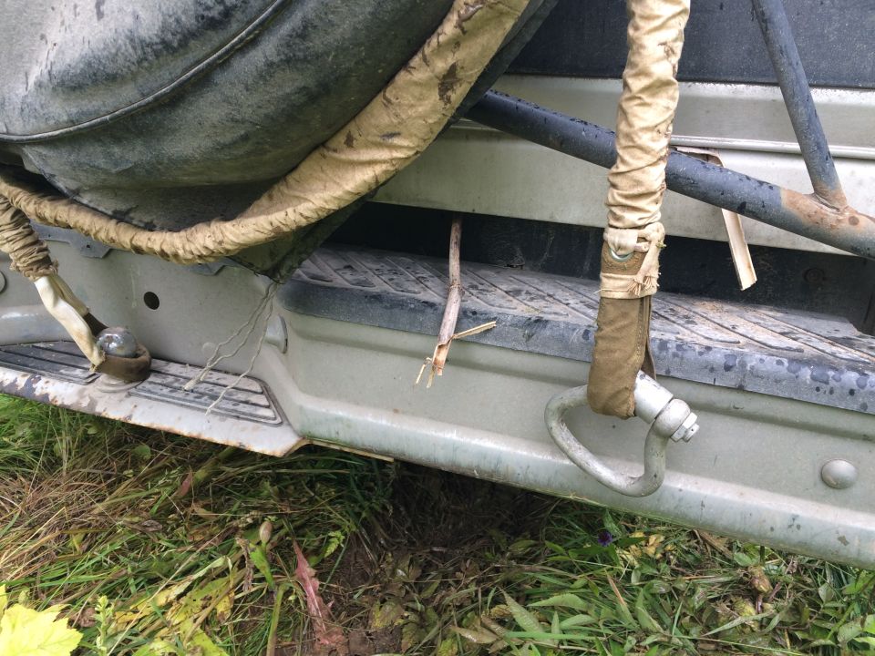 Rear bumper with tow hook and spare tire cover on a vehicle