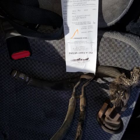 1967 Ford Bronco - A receipt and some car parts are visible on a textured surface.