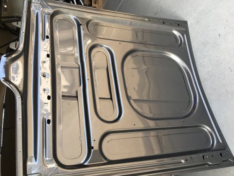 1968 Mercury Cougar - The underside of a car hood shows its internal structure and mounting points.
