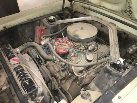 1968 Mercury Cougar - The engine bay of a 1968 Mercury Cougar shows its V8 engine, radiator, and distributor.