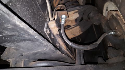 1971 Ford Mustang - Close-up of a vehicle's brake hose assembly, showing the connection to the suspension.