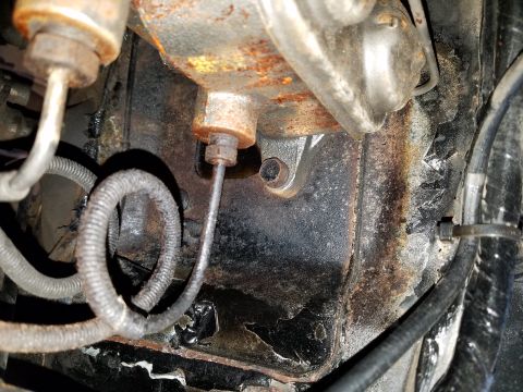 1971 Ford Mustang - The brake master cylinder shows signs of rust and wear, with brake lines connected.