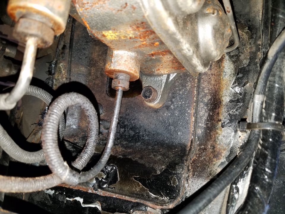 Close-up of a rusty brake master cylinder and brake lines