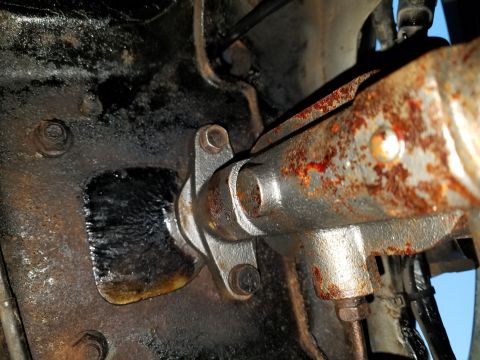 1971 Ford Mustang - Close-up view of a rusty clutch master cylinder, likely from an older vehicle.