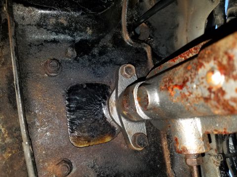 1971 Ford Mustang - Close-up of a rusted steering column bracket, likely from an older vehicle.