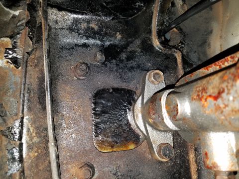 1971 Ford Mustang - This photo shows a close-up view of rusty vehicle frame components and suspension parts.