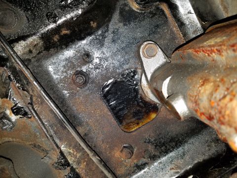 1971 Ford Mustang - Close-up view of a corroded engine mount bracket, indicating significant age and use.