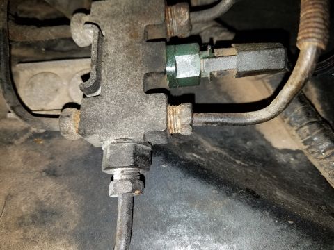 1971 Ford Mustang - Close-up of a vehicle's brake proportioning valve assembly with attached metal brake lines.