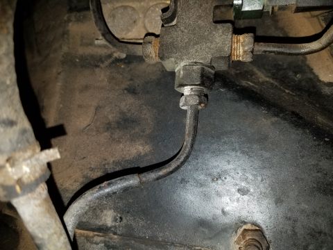 1971 Ford Mustang - This image shows a close-up of a vehicle's brake line junction, not a specific model year.