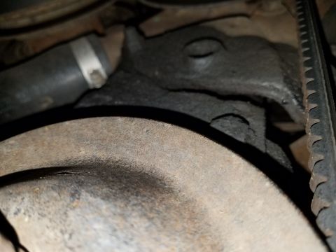 1971 Ford Mustang - Close-up view of an engine component, showing a ribbed belt and a hose clamp.