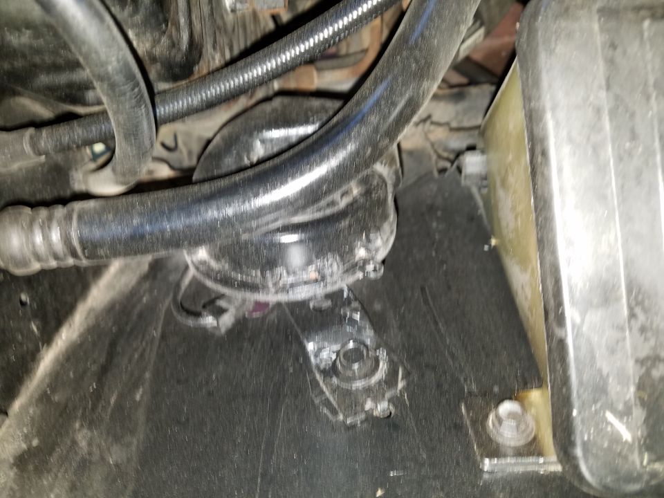 Close-up of hoses and parts in a vehicle's engine bay