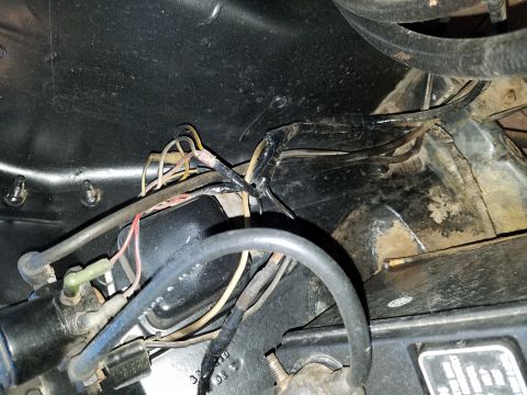 1971 Ford Mustang - The photo shows a section of a vehicle's engine bay with various wires and hoses.