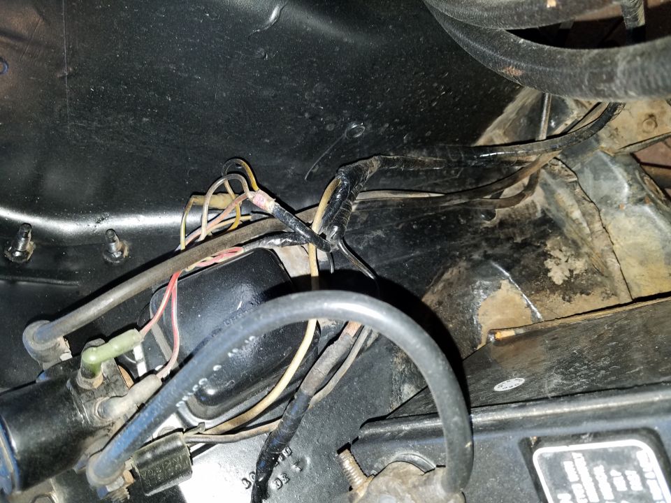 Close-up of engine bay wiring harness and components
