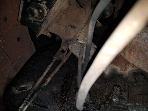 1971 Ford Mustang - Rusty underbody parts and hoses are visible in this close-up view.