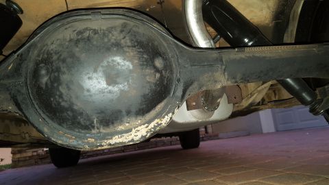 1971 Ford Mustang - Underside view of a vehicle's rear differential and exhaust components, with visible wear and tear.
