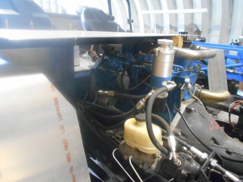 1992 Ford Bronco - Close-up view of an engine bay, showing various mechanical components and hoses.