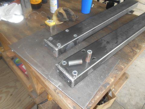1992 Ford Bronco - Metal frame components are laid out on a workbench, suggesting a fabrication or repair project.