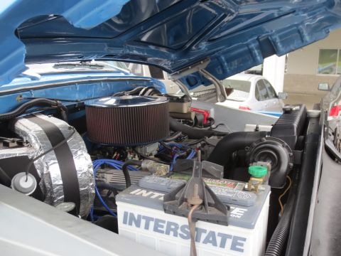 1967 Ford F-250 - Close-up of a vehicle's engine bay, an Interstate battery and air intake system.