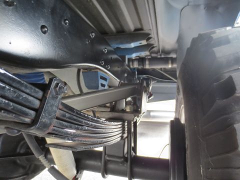 1967 Ford F-250 - Close-up of the rear leaf spring suspension system on a truck.
