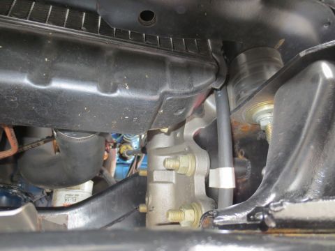 1967 Ford F-250 - Close-up view of the engine bay of a 1967 Ford F-250, showing radiator, hoses, and other mechanical components.