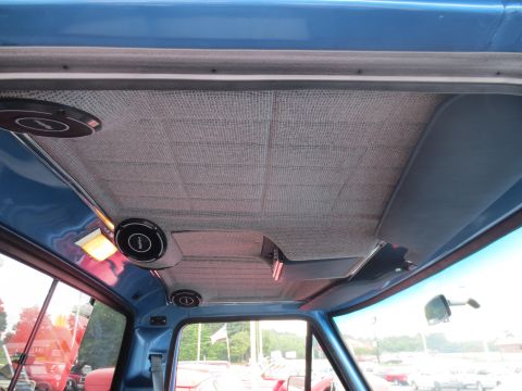 1967 Ford F-250 - The headliner of a blue truck's interior, two speakers and a dome light.