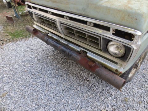 1967 Ford F-250 - Front view of a light blue Ford truck, a chrome grille that identifies it as a 1973 model, equipped with a custom pipe bumper.
