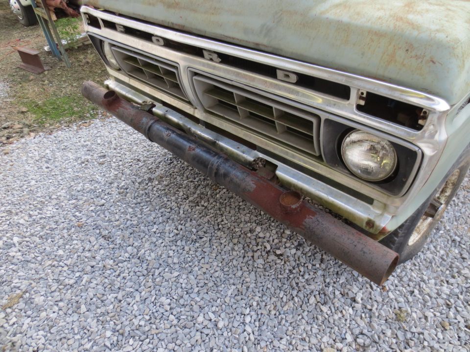 Light blue Ford truck front with chrome grille and custom pipe bumper. Grille indicates 1973 model year