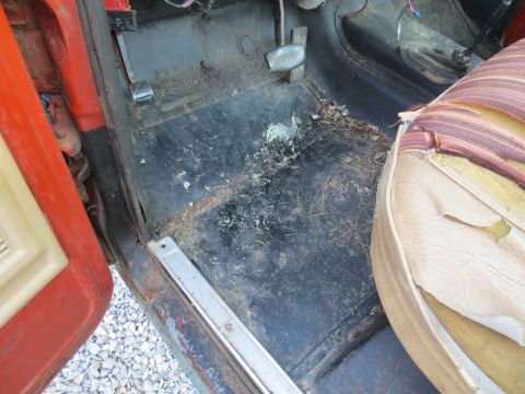 1967 Ford F-250 - The interior of the truck shows a dirty floor and a damaged seat with exposed foam and fabric.