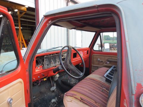 1967 Ford F-250 - Interior view of a vintage truck, showing its worn seats and dashboard.