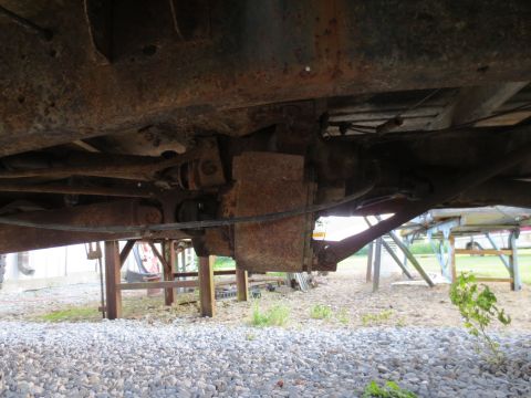 1967 Ford F-250 - The undercarriage of a very rusty truck, showing frame and mechanical parts.