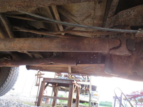 1967 Ford F-250 - The underside of a heavily rusted truck, revealing its drivetrain components and frame structure.