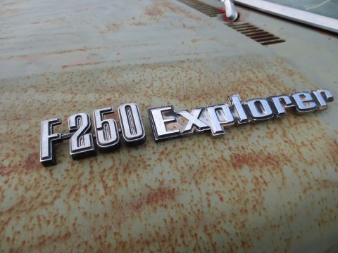 1967 Ford F-250 - The F250 Explorer emblem is visible on the weathered and rusty surface of a vehicle's hood.