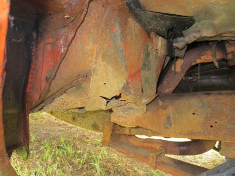 1967 Ford F-250 - The undercarriage of a truck displays extensive rust and structural deterioration.
